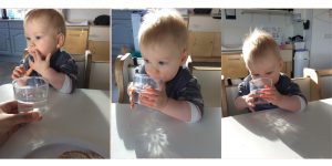 Kind drinkt zelfstandig uit doorzichtige beker